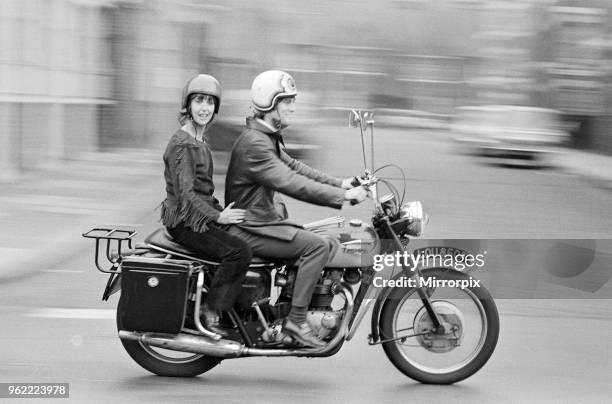 Actress Una Stubbs and her husband Nicky Henson arrive at the Young Vic Theatre for a dress rehearsal on their motorbike. They are appearing in the...