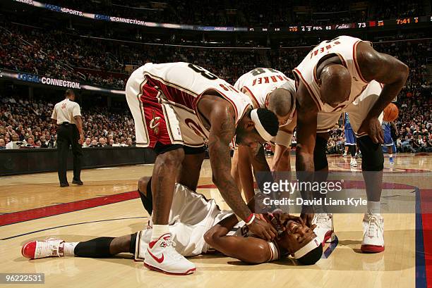 LeBron James, Anthony Parker and Shaquille O'Neal of the Cleveland Cavaliers tickle the chin of Daniel Gibson after he takes a charge against the...