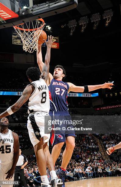 Zaza Pachulia of the Atlanta Hawks is blocked by Roger Mason, Jr. #8 of the San Antonio Spurs on January 27, 2010 at the AT&T Center in San Antonio,...