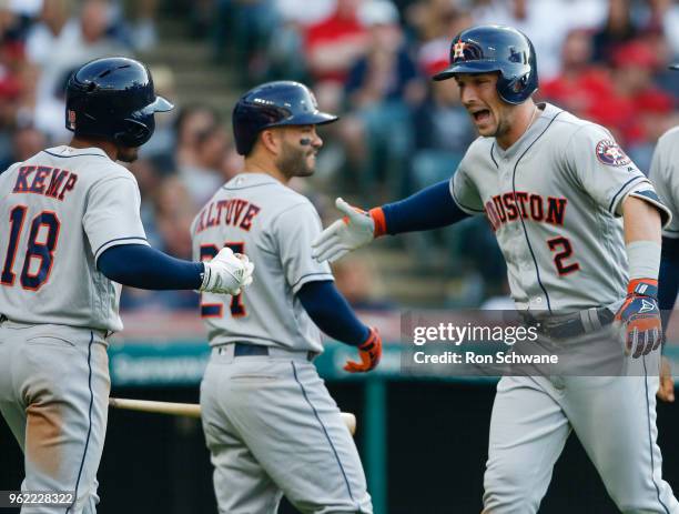 Alex Bregman of the Houston Astros celebrates with Jose Altuve and Tony Kemp after hitting a three run home run off Mike Clevinger of the Cleveland...