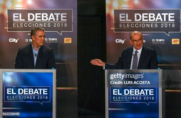 Liberal Party candidate Humberto de la Calle and Ivan Duque for the Democratic Center Party take part in a TV debate in Bogota on May 24, 2018. -...
