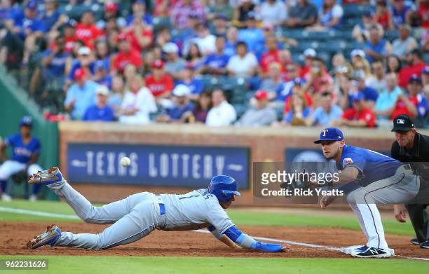 Ryan Goins of the Kansas City Royals beats the tag against Ryan Rua of the Texas Rangers in the second inning at Globe Life Park in Arlington on May...