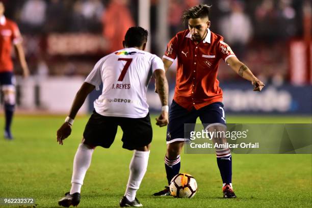 Martin Benitez of Independiente competes for the ball with Jose Reyes of Deportivo Lara during a match between Independiente and Deportivo Lara as...