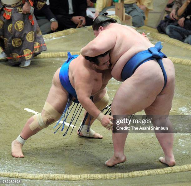 Kotoshogiku pushes Mongolian sekiwake Ichinojo out of the ring to win on day twelve of the Grand Sumo Summer Tournament at Ryogoku Kokugikan on May...