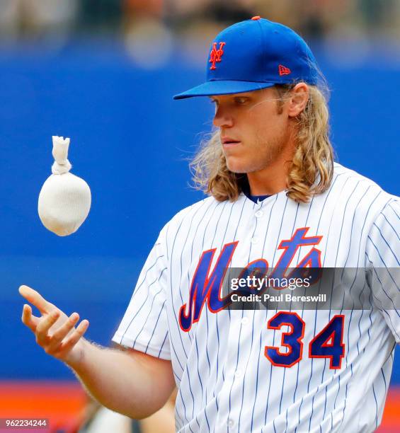 Pitcher Noah Syndergaard of the New York Mets tosses the rosin bag on the mound as he pitches in an MLB baseball game against the Arizona...