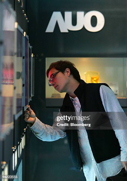 Visitor looks at liquid-crystal display screens at AU Optronics Corp.'s headquarters in Hsinchu, Taiwan, on Tuesday, Jan. 26, 2010. AU Optronics...