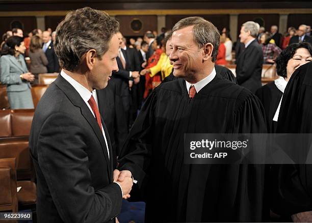 Treasury Secretary Timothy Geithner and Supreme Court Chief Justice John Roberts shake hands on the floor of the US House of Representatives shortly...