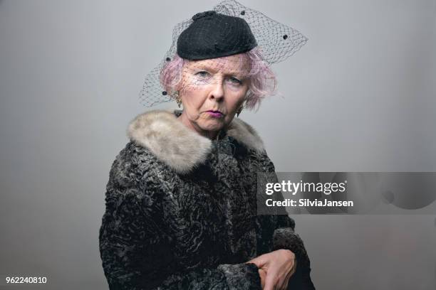 senior lady in retro style grief - black woman fur coat stock pictures, royalty-free photos & images