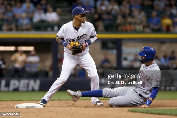 Orlando Arcia of the Milwaukee Brewers forces out Wilmer Flores of the New York Mets at second base in the fifth inning at Miller Park on May 24,...