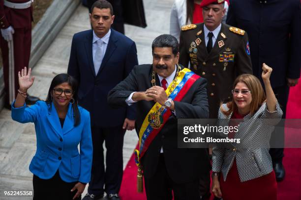 Nicolas Maduro, Venezuela's president, center, gestures as Delcy Rodriguez, president of the Constituent Assembly, left, and Cilia Flores, first lady...