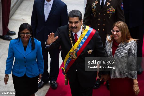 Nicolas Maduro, Venezuela's president, center, waves as he arrives with Delcy Rodriguez, president of the Constituent Assembly, left, and Cilia...