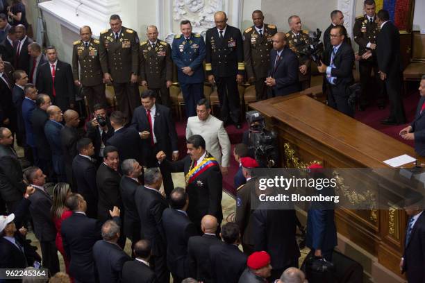 Nicolas Maduro, Venezuela's president, center, gestures as he greets lawmakers during a swearing-in ceremony in Caracas, Venezuela, on Thursday, May...