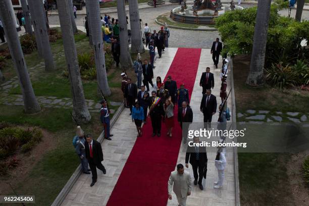 Nicolas Maduro, Venezuela's president, center, and Cilia Flores, first lady of Venezuela, center right, wave as they arrive with Delcy Rodriguez,...