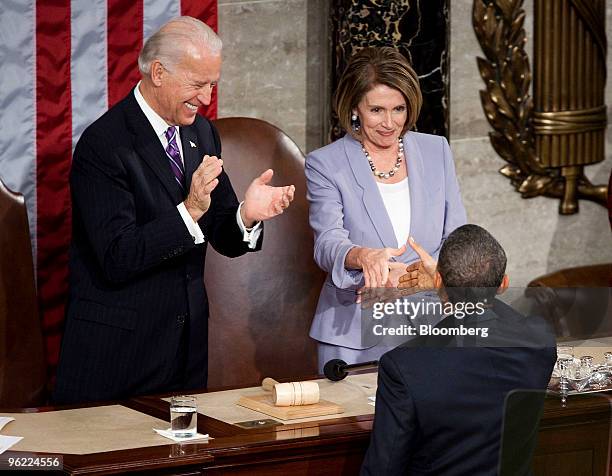 President Barack Obama greets U.S. Vice President Joseph "Joe" Biden, top left, and House Speaker Nancy Pelosi, top right, before delivering the...