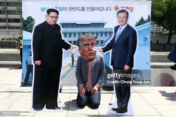 South Korean protester wears a mask of U.S. President Donald Trump during a rally to demand a U.S. And North Korea summit on May 25, 2018 in Seoul,...