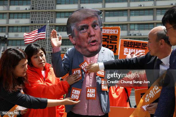 South Korean protester wears a mask of U.S. President Donald Trump during a rally to demand a U.S. And North Korea summit on May 25, 2018 in Seoul,...