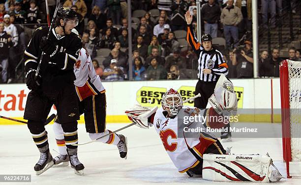 Goaltender Miikka Kiprusoff of the Calgary Flames makes a save in front of James Neal of the Dallas Stars in the third period at American Airlines...