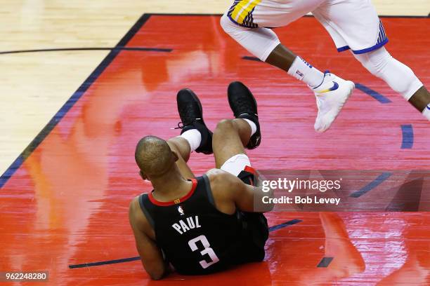 Chris Paul of the Houston Rockets grabs his leg after falling against the Golden State Warriors in the fourth quarter of Game Five of the Western...