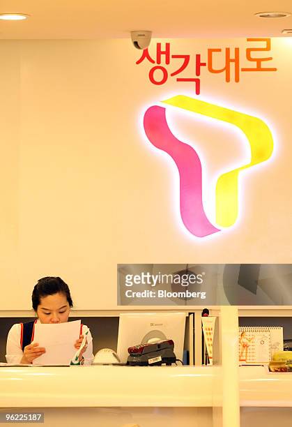 An employee works at SK Telecom Co.'s T World brand shop in Seoul, South Korea, on Thursday, Jan. 28, 2010. SK Telecom Co., South Korea's largest...
