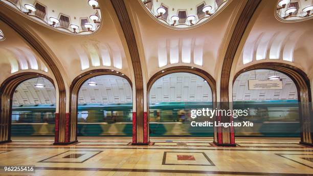 mayakovskaya metro station with train running through, moscow, russia - moscow railway station stock pictures, royalty-free photos & images