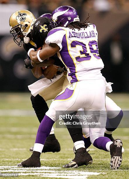 Courtney Roby of the New Orleans Saints is tackled while returning a kick by Husain Abdullah of the Minnesota Vikings during the NFC Championship...