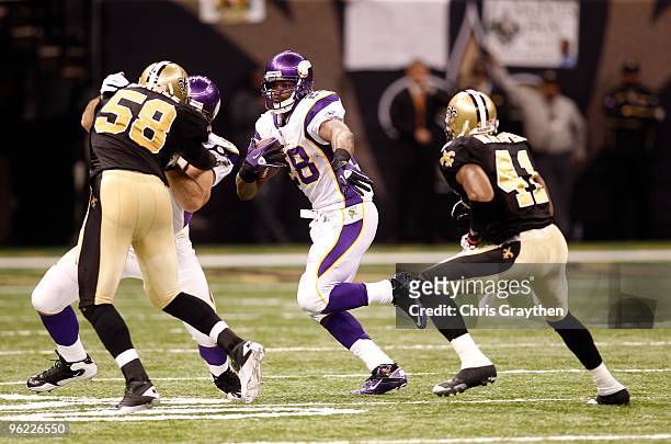 Adrian Peterson of the Minnesota Vikings runs the ball against the New Orleans Saints during the NFC Championship Game at the Louisiana Superdome on...