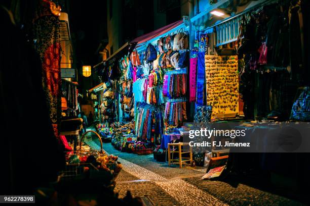 shops with arab style souvenir in the streets of granada - granada stock-fotos und bilder