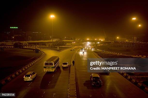 In this January 27, 2009 photograph, a Compressed Natural Gas blue line bus is driven down a road in New Delhi . AFP PHOTO/ Manpreet ROMANA