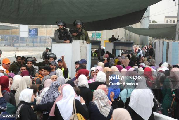 Palestinian women and children cross Qalandiya checkpoint to perform second Friday Prayer of Islamic holy month Ramadan at the Al-Aqsa Mosque after...