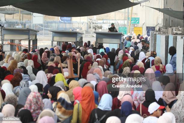 Palestinian women and children cross Qalandiya checkpoint to perform second Friday Prayer of Islamic holy month Ramadan at the Al-Aqsa Mosque after...