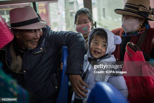 Man with his granddaughter seen inside a local bus in Shangri-La.