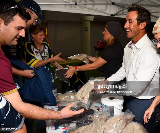 Andrew Johns helps sell fundraising beanies from the Mark Hughes Foundation before the start the round 12 NRL match between the North Queensland...