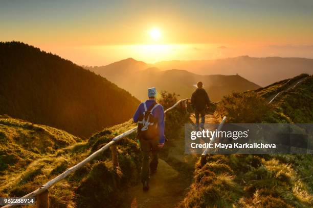 friends walking at sunset at sete cidades lakes, sao miguel island, azores, atlantic ocean, portugal - cidades foto e immagini stock