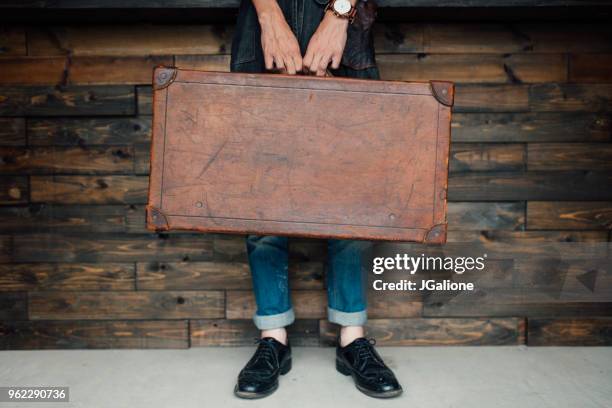 lower section of a man holding a leather case - leather goods stock pictures, royalty-free photos & images