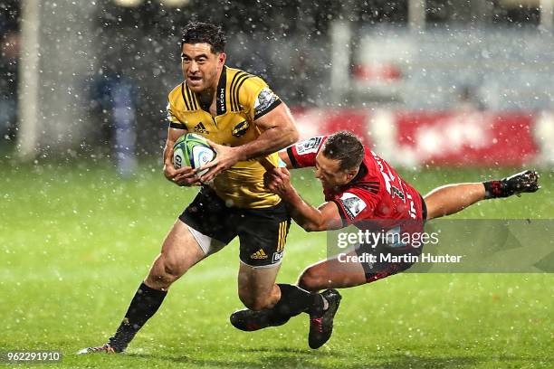 Nehe Milner-Skudder of the Hurricanes is tackled by Tim Bateman of the Crusaders during the round 15 Super Rugby match between the Crusaders and the...