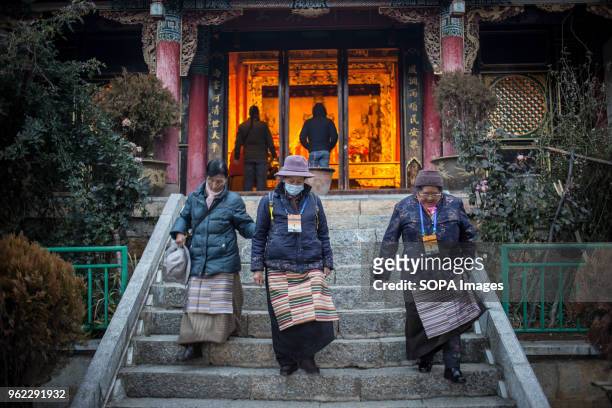 Tibetan woman seen going down the steps at the Tibetan Temple 'Guishan' at the Turtle Mountain Park in Shangri-La.