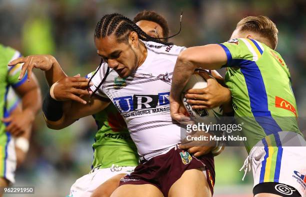 Martin Taupau of the Eagles is tackled during the round 12 NRL match between the Canberra Raiders and the Manly Sea Eagles at GIO Stadium on May 25,...