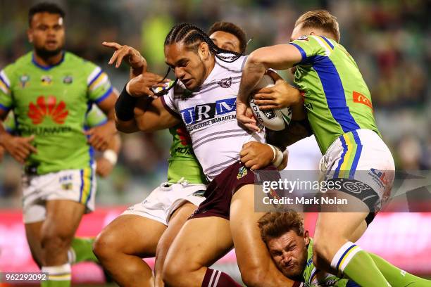 Martin Taupau of the Eagles is tackled during the round 12 NRL match between the Canberra Raiders and the Manly Sea Eagles at GIO Stadium on May 25,...