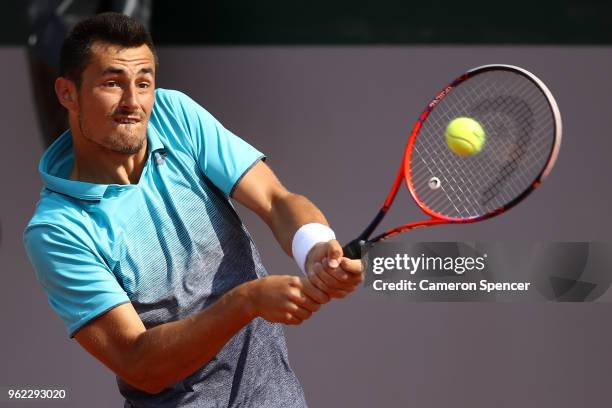 Bernard Tomic of Australia plays a backhand during his French Open third round menÕs qualifying singles match against Goncalo Oliveira of Portugal at...