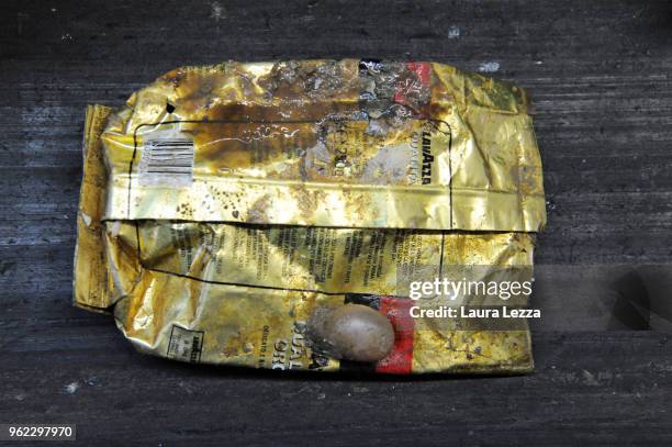 Package of Lavazza coffee is displayed inside the company Revet Recycling while workers select the plastic waste collected by the fishermen inside...