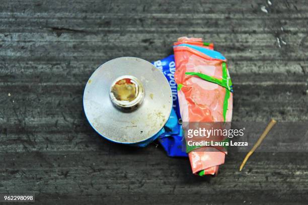 Tomato tube is displayed inside the company Revet Recycling while workers select the plastic waste collected by the fishermen inside the nets on a...