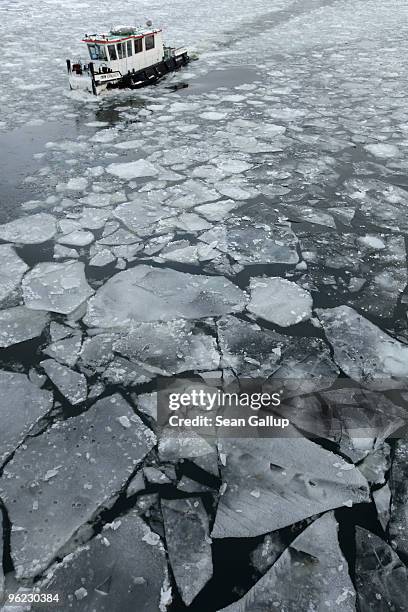 An icebreaker churns through ice in the Dahme river in the district of Koepenick on January 28, 2010 in Berlin, Germany. Though temperatures are mild...