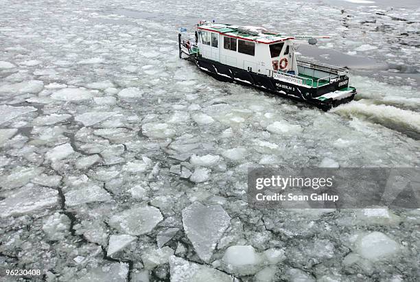 An icebreaker churns through ice in the Dahme river in the district of Koepenick on January 28, 2010 in Berlin, Germany. Though temperatures are mild...