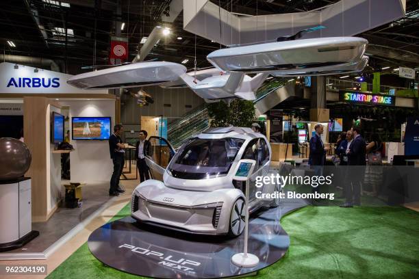 An Audi pop.up next self driving automobile and passenger drone concept vehicle, developed by Audi AG and Airbus SE, sits on display during the Viva...