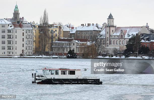 An icebreaker churns through ice in the Dahme river in the district of Koepenick on January 28, 2010 in Berlin, Germany. Though temperatures are mild...