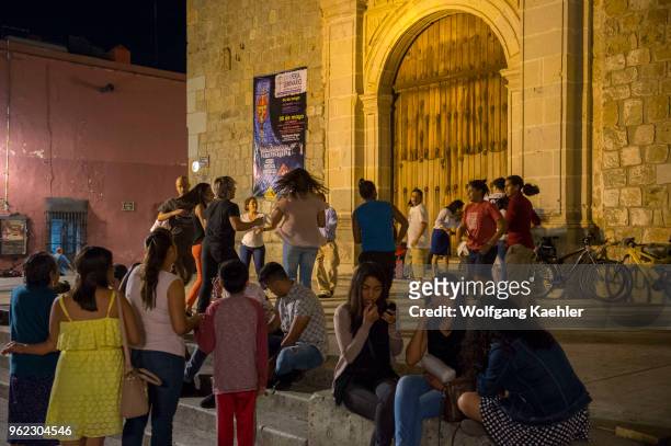 People at night dancing in front of the church Sangre De Cristo in the city of Oaxaca de Juarez, Oaxaca, Mexico.