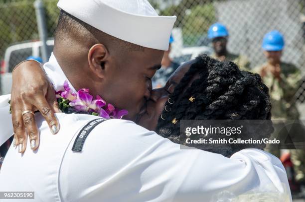 Photograph of 1st Class Dee-Mar-Kee H Aytche and his wife kissing following the navy's guided-missile destroyer USS Halsey's homecoming after a...