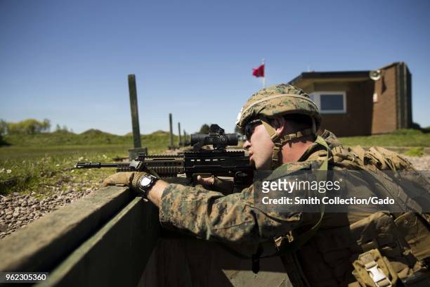 Photograph of US Corporal William Ring using an SA80 A2 assault rifle during the British Royal Marine Operational Shooting Competition held at Altcar...
