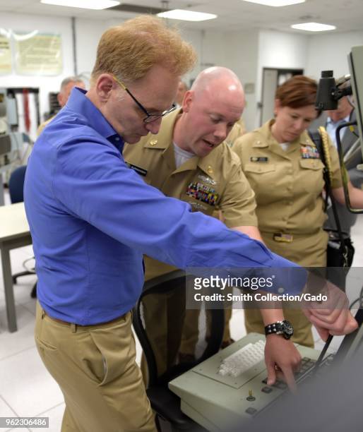 Photograph of the US navy's Chief Cryptologic Technician Michael Burngasser demonstrating AN/SLQ-32 course equipment for Undersecretary of the Navy...