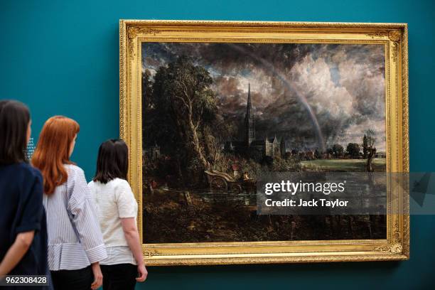 Tate employees pose with 'Salisbury Cathedral from the Meadows', 1831 by John Constable during a photo call at Tate Britain on May 25, 2018 in...